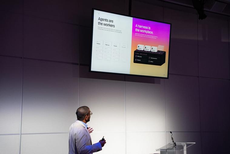 Agents are the workers. A harness is the workspace. Devang in front of a slide reading Agents are the workers, a harness is the workspace